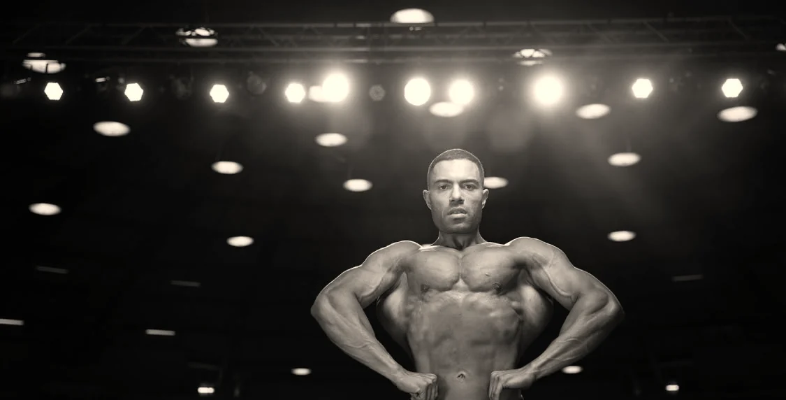 Dr. Jeremy Goodman on stage at a bodybuilding competition