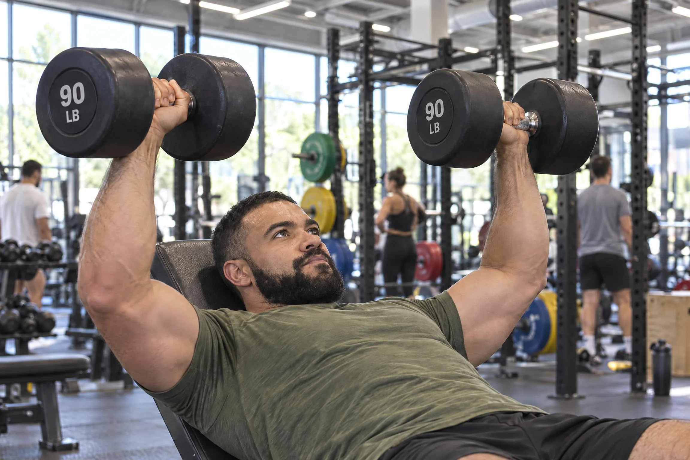 Dr. Jeremy Goodman training with a pair of 90-pound dumbbells