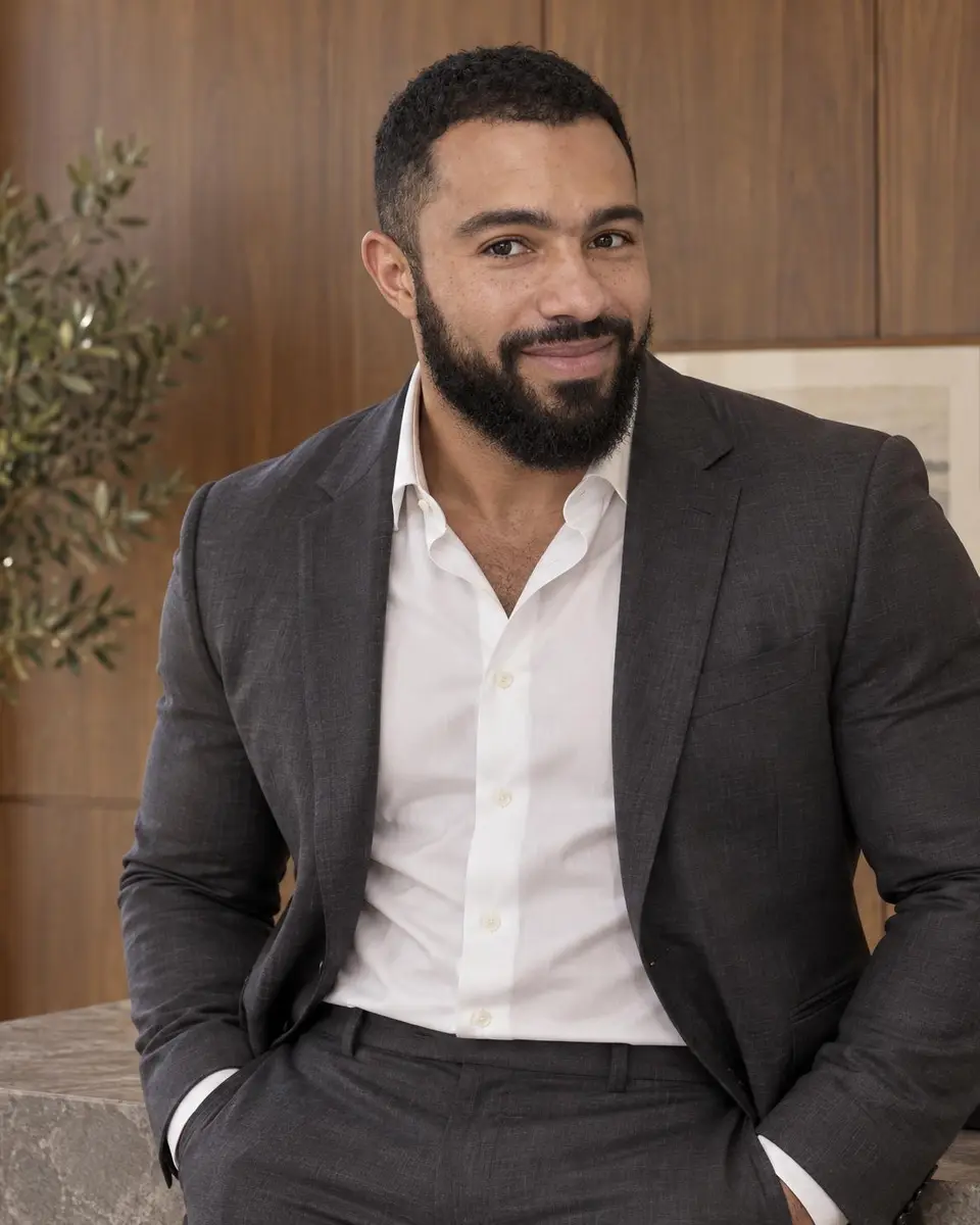 Dr. Jeremy Goodman, urologist, in a charcoal suit and open white shirt