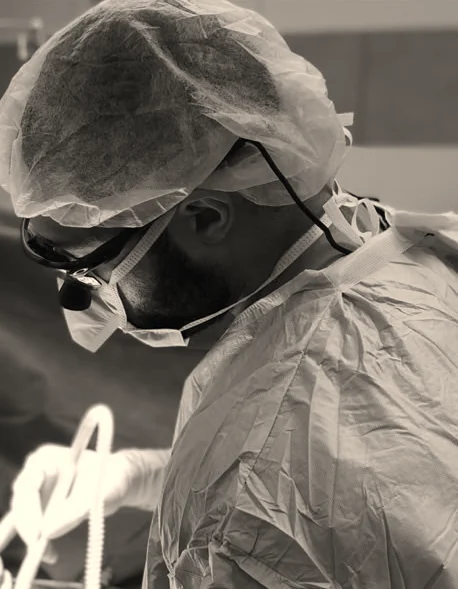 Dr. Jeremy Goodman in the operating room wearing surgical loupes
